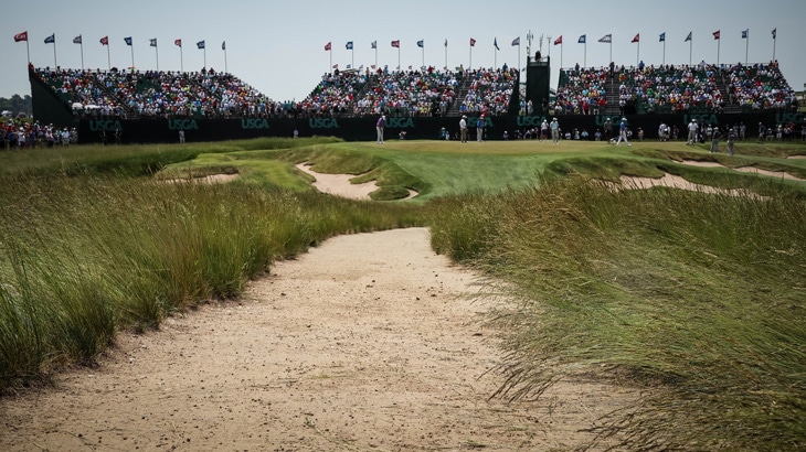 The players walk up to the par-3, No. 9, is a...