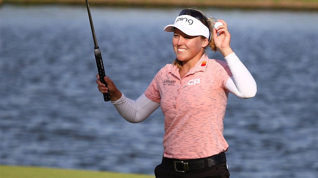 Brooke Hnderson raises her Pro V1 golf ball in celebration after holing the final putt to win the 2019 LOTTE Championship