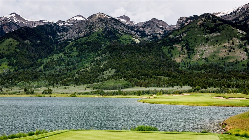 Image of golf course with mountains in the background.